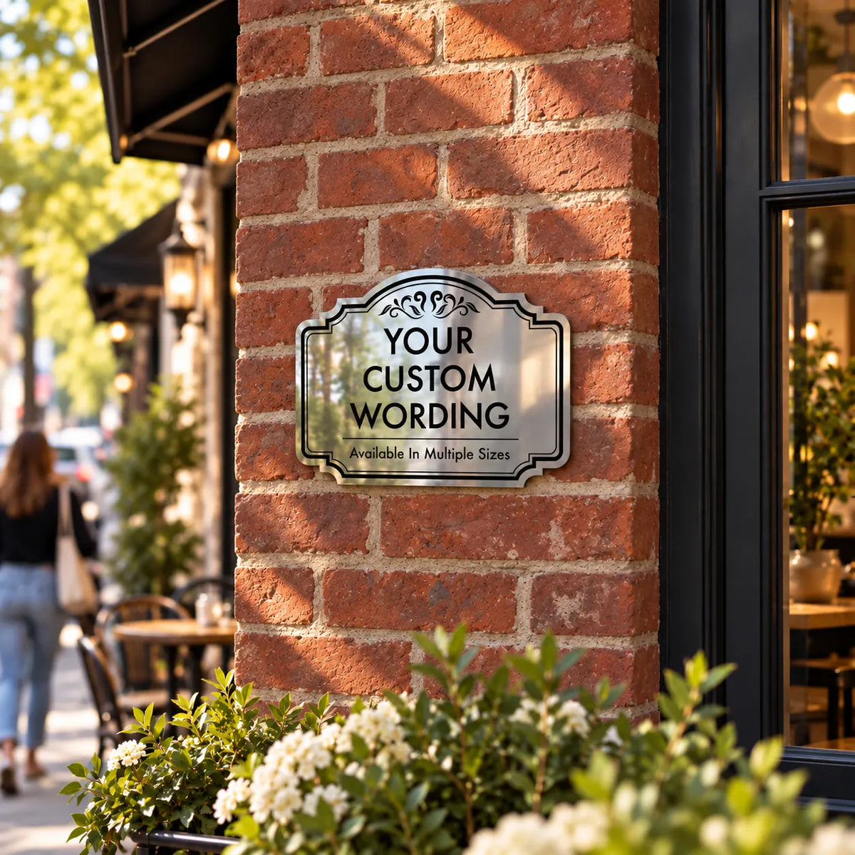 Smaller size custom mirror finish aluminum sign on a brick corner beside a café patio