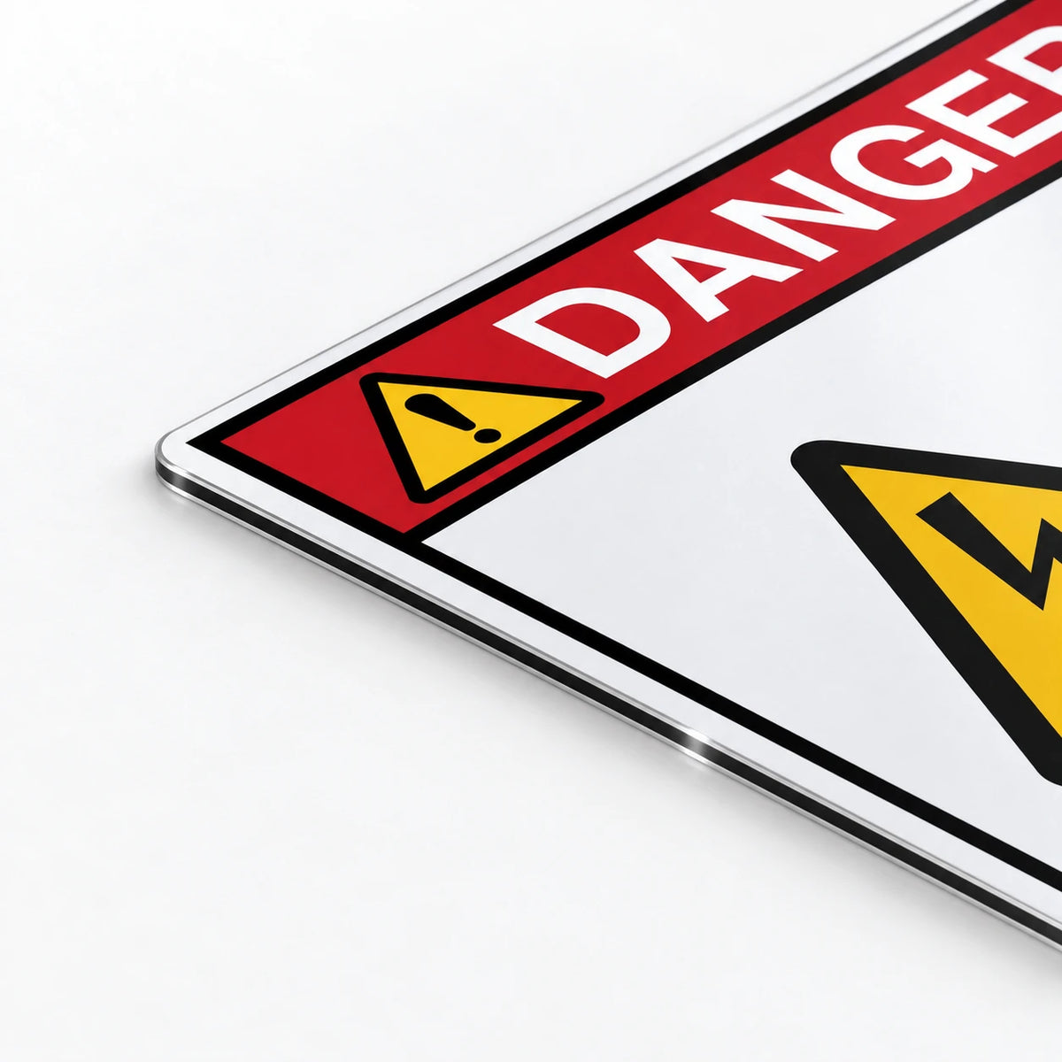 A close-up of a clear acrylic warning sign with a red header reading 'DANGER' and yellow hazard icons, shown on a white background.