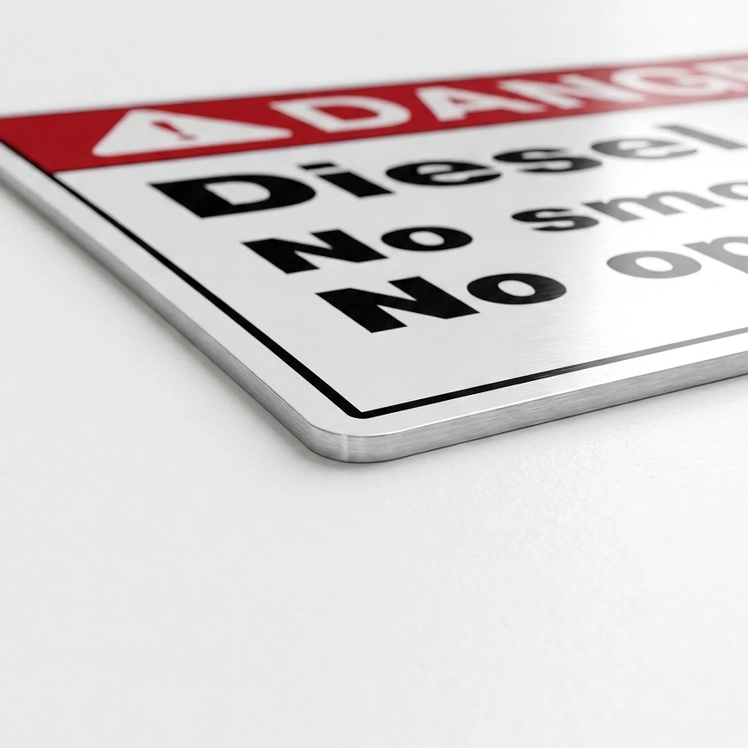 A close-up of a rectangular warning sign with a red header and black text.