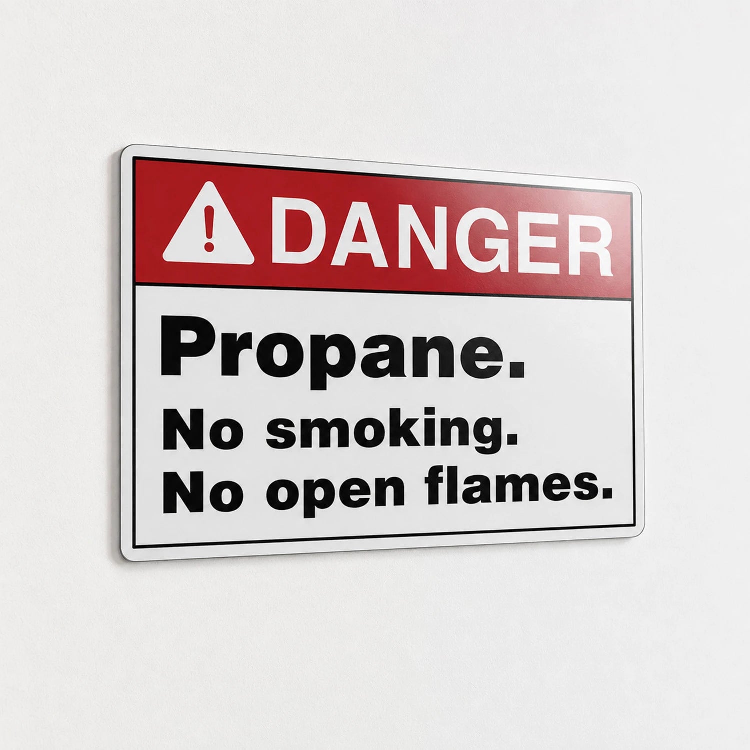 A rectangular warning sign with a red header reading 'DANGER' and a white lower section that says 'Propane. No smoking.