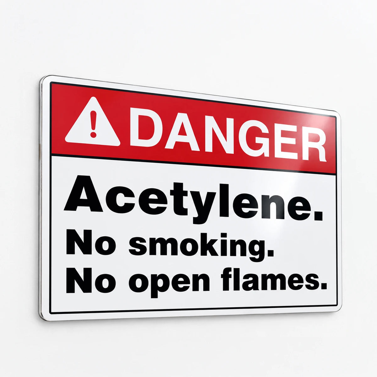 A rectangular warning sign with a red header reading “DANGER” and black text below stating “Acetylene. No smoking.