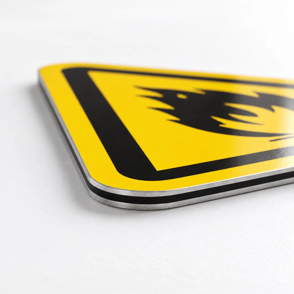 Close-up of the flame pictogram printed on aluminum flammable warning sign