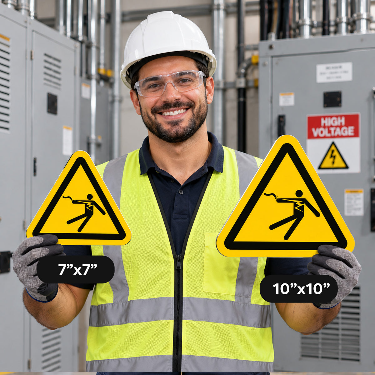 A smiling construction worker in a white hard hat and high-visibility vest holds two yellow triangular warning signs with black borders and a falling figure symbol. One sign is labeled 7"x7" and the other 10"x10".