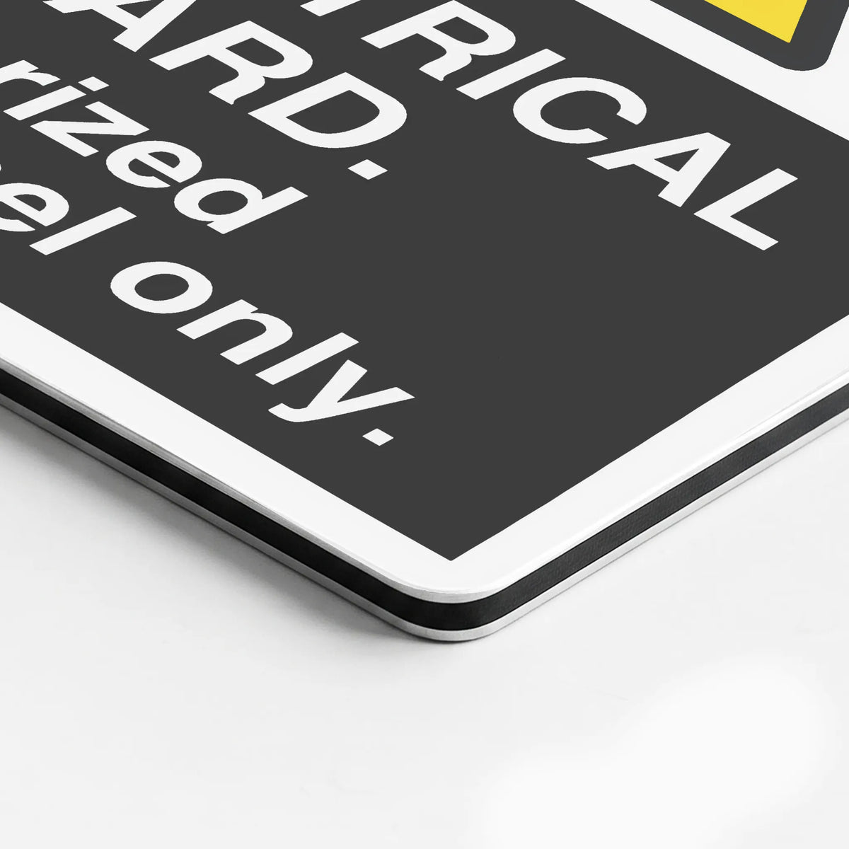 A close-up of a black warning sign with white text reading 'CAUTION' and 'fuel only.' on a white surface.