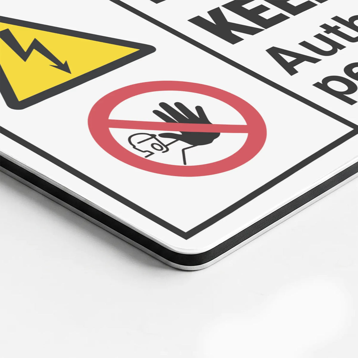 Close-up of the High Voltage Keep Away Authorized Personnel Only sign's printed surface and rounded edge
