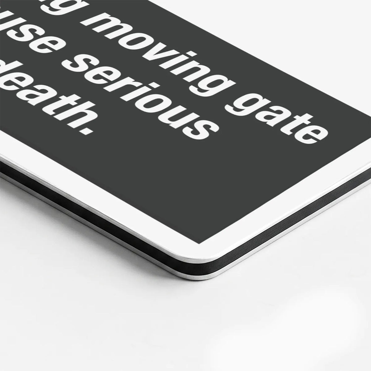 Close-up of the Moving Gate Can Cause Serious Injury or Death sign's printed surface and rounded edge