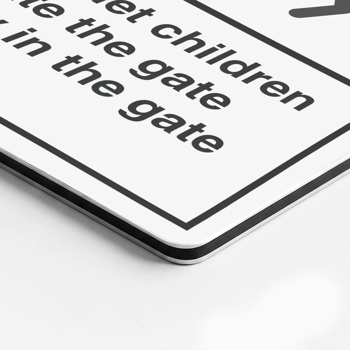 Close-up of the Do Not Let Children Operate the Gate sign's printed surface and rounded edge