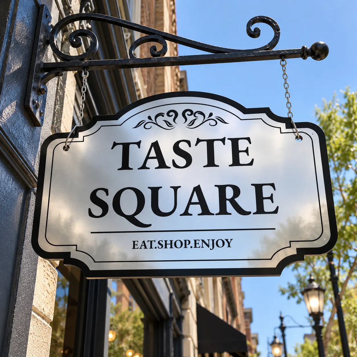 Double-sided Ornate Scroll mirror finish sign reading Taste Square hanging from an iron bracket on a city street